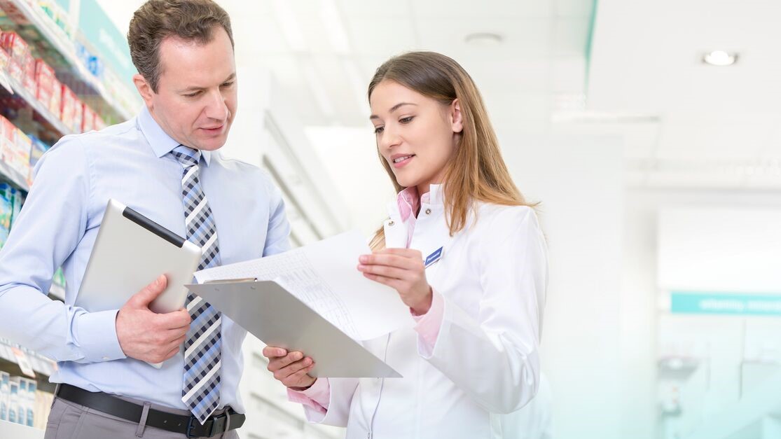 Pharmacist and businessman having a discussion